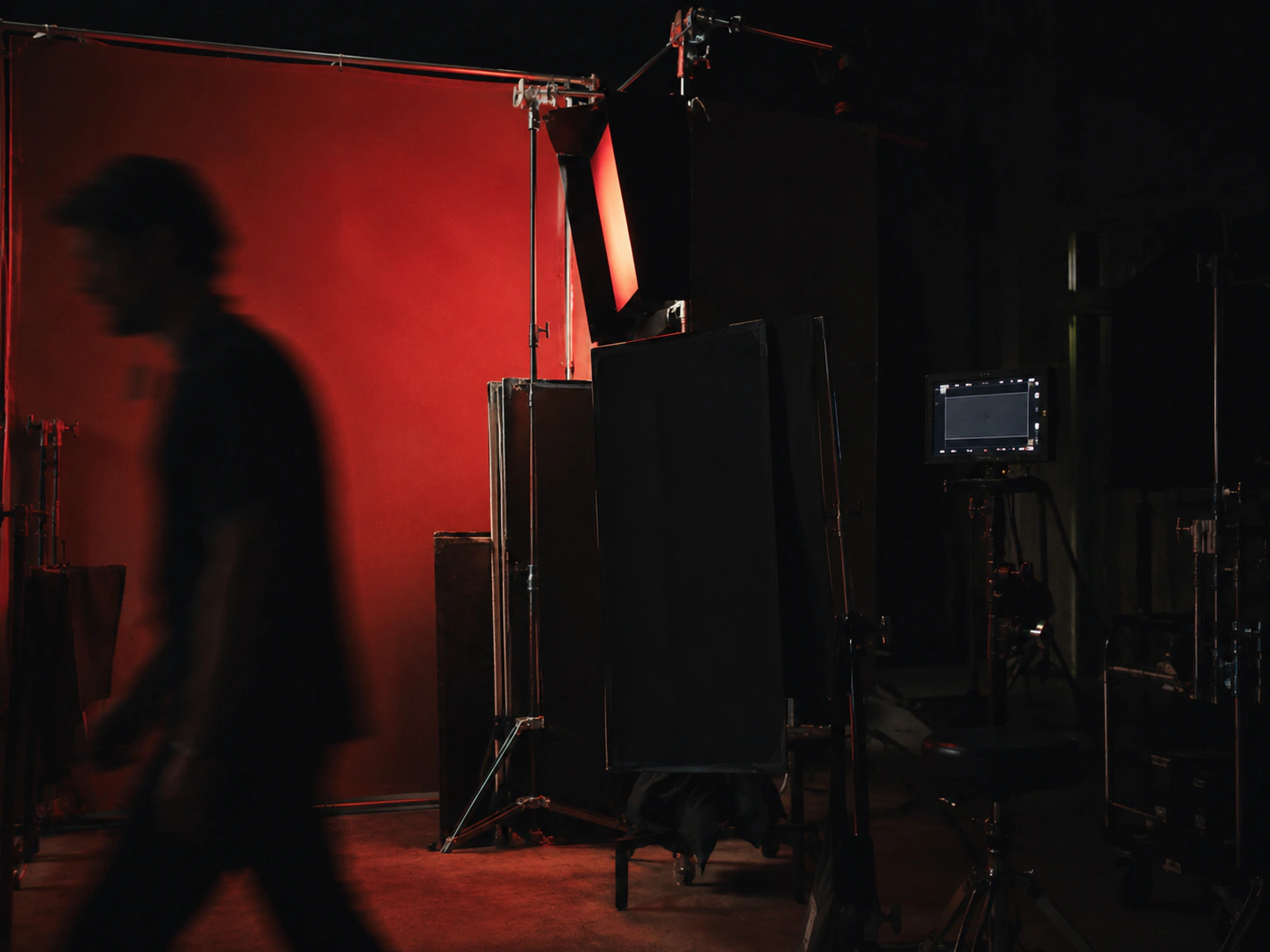 A dark campaign production set illuminated in red